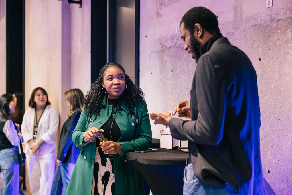Two African entrepreneurs changing contacts after tech conference