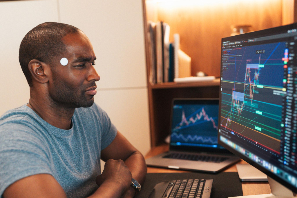 Cryptocurrency trader analyzing market charts on multiple screens